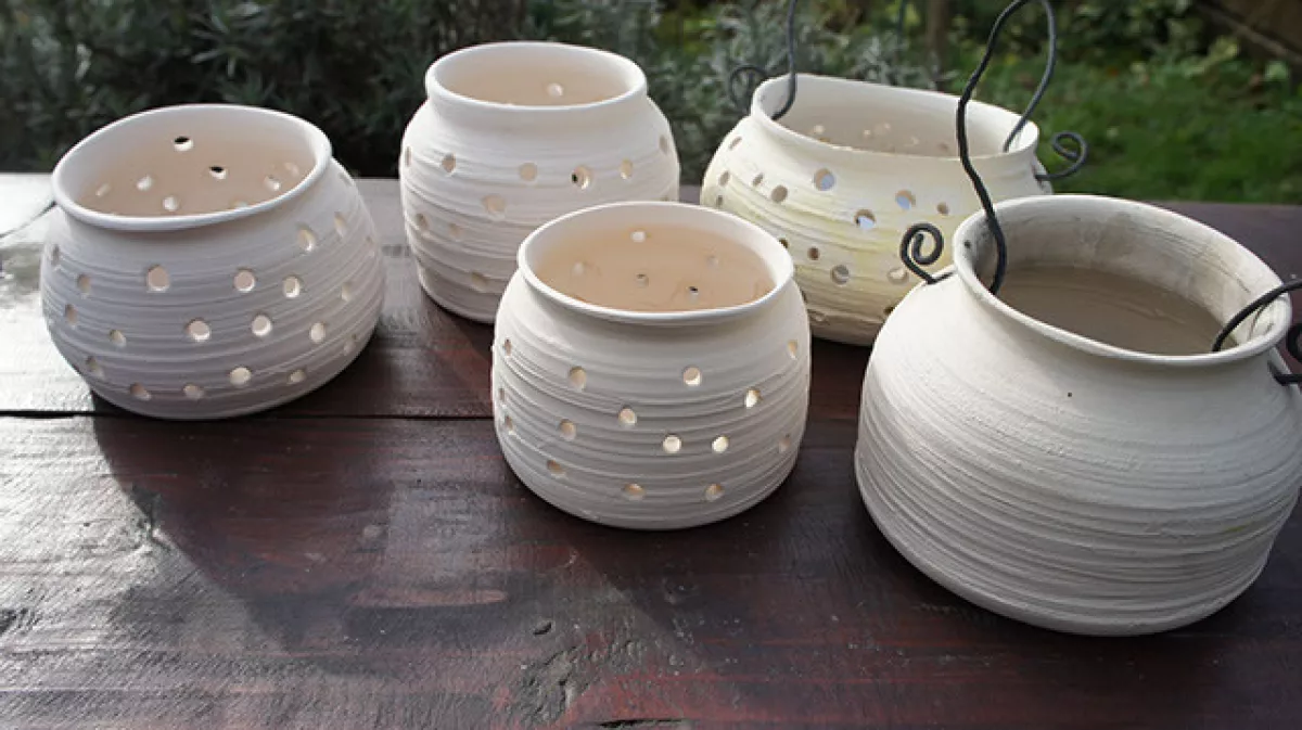 White candle pots on a garden table