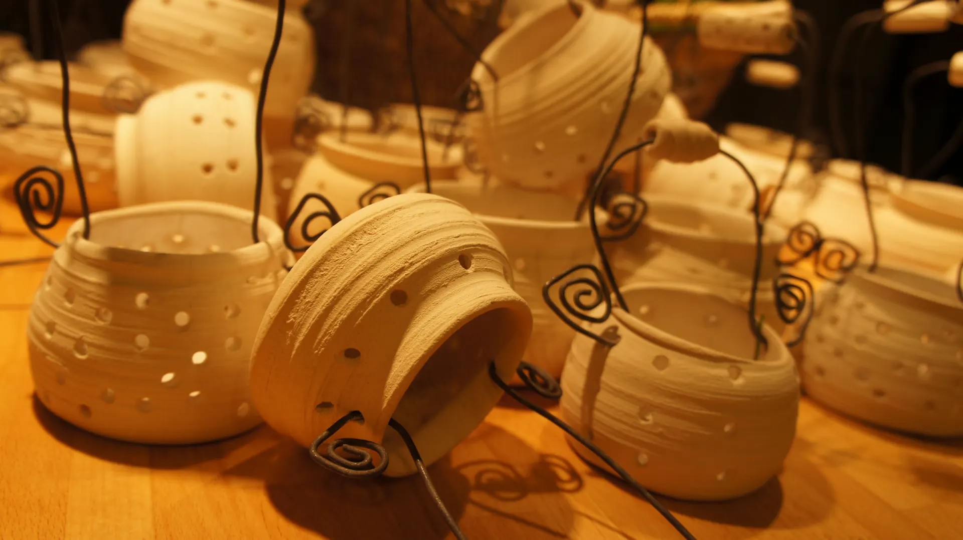Pottery with wire spirals in warm light