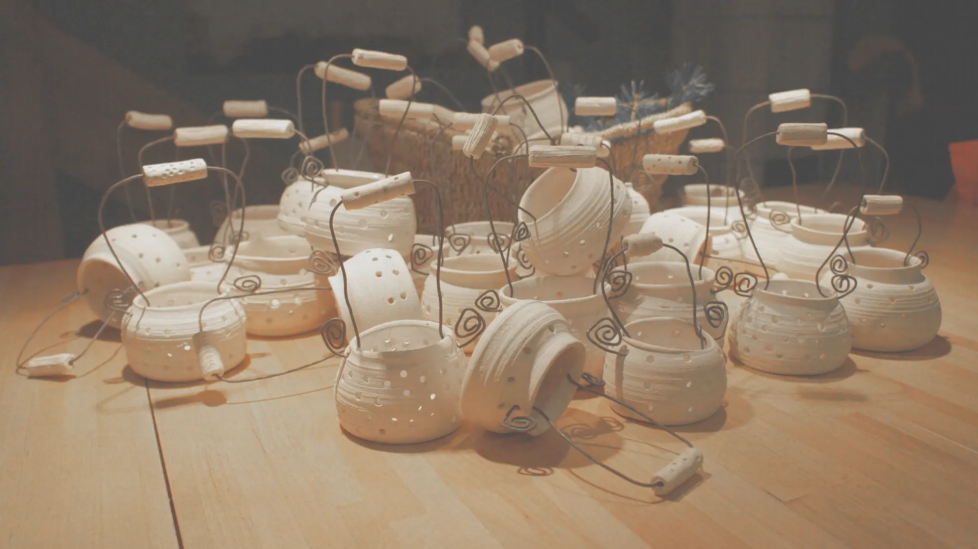 Pots with wire handles and wooden toggles on a table
